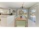 Bright kitchen and dining area featuring white cabinets and a bamboo dining table with sliding door access to the pool at 18082 Eau Gallie S Cir, Port Charlotte, FL 33948