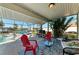 Enjoy outdoor dining on this screened lanai with comfortable seating and a grill at 18082 Eau Gallie S Cir, Port Charlotte, FL 33948