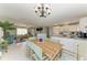 Bright living area featuring tiled flooring, access to the kitchen, and a bamboo dining table at 18082 Eau Gallie S Cir, Port Charlotte, FL 33948
