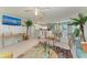 Open-concept living room seamlessly connected to the kitchen and dining area, bright and airy at 18082 Eau Gallie S Cir, Port Charlotte, FL 33948