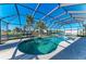 Relax poolside in the enclosed pool area with waterfront views at 18082 Eau Gallie S Cir, Port Charlotte, FL 33948