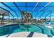 Enjoy the private pool, enclosed for year-round enjoyment and waterfront views at 18082 Eau Gallie S Cir, Port Charlotte, FL 33948