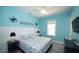 Bright coastal bedroom with nautical decor, featuring a blue accent wall, white wainscoting at 212 Spring Ave, Anna Maria, FL 34216