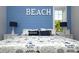 Bright bedroom with nautical theme, blue accent wall, white trim, and decorative bedding at 212 Spring Ave, Anna Maria, FL 34216