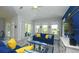 Bright and airy living room with comfortable blue sofas, a surfboard coffee table, and a coastal vibe at 212 Spring Ave, Anna Maria, FL 34216