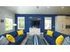 Nautical themed living room with blue couches, white furniture, and marine-inspired decor at 212 Spring Ave, Anna Maria, FL 34216
