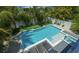 Aerial view of a backyard with swimming pool, putting green, spa, and outdoor lounging area at 212 Spring Ave, Anna Maria, FL 34216