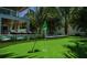 Beautiful putting green with in-ground pool and patio with several lounge chairs at 212 Spring Ave, Anna Maria, FL 34216
