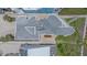 Aerial view of a modern home highlighting the roof, landscaping, and surrounding properties at 216 Tenacity Ln, Sarasota, FL 34242