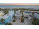 Aerial view of a luxurious beach house with multiple decks overlooking the ocean, surrounded by pristine beaches at 216 Tenacity Ln, Sarasota, FL 34242