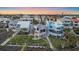 Aerial view showcases beachfront homes, unique architecture, and lush lawns for serene coastal living in paradise at 216 Tenacity Ln, Sarasota, FL 34242