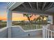Picturesque view from a covered balcony showcasing swaying palm trees and the serene oceanfront at 216 Tenacity Ln, Sarasota, FL 34242