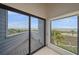 Balcony overlooking the beach and ocean with sliding glass doors and grey siding at 216 Tenacity Ln, Sarasota, FL 34242