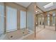 Bathroom featuring soaking tub, mirrored closet doors, and neutral-toned wallpaper at 216 Tenacity Ln, Sarasota, FL 34242