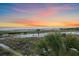 Breathtaking beach view with sand, vegetation, and colorful sunset at 216 Tenacity Ln, Sarasota, FL 34242