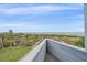 Breathtaking beach view showcasing tropical vegetation, white sands, and clear ocean waters from a private balcony at 216 Tenacity Ln, Sarasota, FL 34242