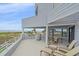 A well-appointed outdoor deck with ocean views and outdoor furniture at 216 Tenacity Ln, Sarasota, FL 34242