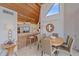 Dining area features a wooden ceiling, access to kitchen and is brightened by a window with ocean views at 216 Tenacity Ln, Sarasota, FL 34242