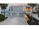 Charming beach house boasts a two-car garage, well-lit entrance, and a meticulously landscaped yard for curb appeal at 216 Tenacity Ln, Sarasota, FL 34242