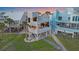 Stylish coastal home with multiple balconies, elevated design, and well-maintained landscaping at 216 Tenacity Ln, Sarasota, FL 34242