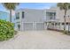 Beautiful two-story home featuring a two-car garage and landscaped yard, showcasing modern coastal living at 216 Tenacity Ln, Sarasota, FL 34242