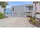 Charming two-story home with a two-car garage and coastal landscaping, offering curb appeal and convenience at 216 Tenacity Ln, Sarasota, FL 34242