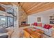 The stone fireplace and spiral staircase define the living room, with an ocean view, and ample seating at 216 Tenacity Ln, Sarasota, FL 34242