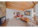 Cozy living room showcases a stone fireplace, a large couch, and decor, blending comfort with architectural charm at 216 Tenacity Ln, Sarasota, FL 34242