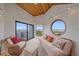 Bright living room with futon, chair, and sliding glass doors with ocean view at 216 Tenacity Ln, Sarasota, FL 34242
