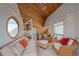 Living room features vaulted wood ceiling, wet bar, comfortable seating, and a circular window at 216 Tenacity Ln, Sarasota, FL 34242