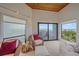 Bright living room with chairs and sliding glass doors with ocean view at 216 Tenacity Ln, Sarasota, FL 34242