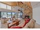 Expansive living room boasts a stone fireplace, wood ceiling, and stunning ocean views from large sliding doors at 216 Tenacity Ln, Sarasota, FL 34242