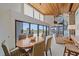 Open living area includes dining and ocean view, wooden ceilings, and staircase for a connected living experience at 216 Tenacity Ln, Sarasota, FL 34242