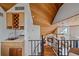 Loft view of wood ceiling and stairs looking down to the living room with wet bar at 216 Tenacity Ln, Sarasota, FL 34242