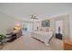 Spacious main bedroom with a ceiling fan, tv, and adjacent office space at 216 Tenacity Ln, Sarasota, FL 34242