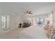 Comfortable main bedroom with ceiling fan, tv and adjacent office overlooking the beach at 216 Tenacity Ln, Sarasota, FL 34242
