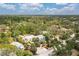 Aerial image of a property with a pool, surrounded by lush greenery and trees at 2165 Lemon Ave, Englewood, FL 34223