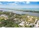 Aerial view of a house surrounded by trees, a bay, and a small bridge nearby at 2165 Lemon Ave, Englewood, FL 34223