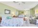 Spacious green bedroom with two beds, sitting area, and ceiling fans at 2165 Lemon Ave, Englewood, FL 34223