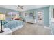 Bright bedroom with blue walls, multiple windows, and door leading to outdoor area at 2165 Lemon Ave, Englewood, FL 34223