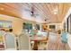 Open dining area with wood-paneled ceilings and outdoor access at 2165 Lemon Ave, Englewood, FL 34223