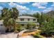 Charming two-story home with a pergola, landscaped yard, and mature palm trees at 2165 Lemon Ave, Englewood, FL 34223