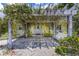 Inviting front entrance with a vine-covered pergola and cozy bench seating at 2165 Lemon Ave, Englewood, FL 34223
