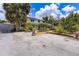 Home with a trellis-covered porch, nice landscaping, and a gravel driveway at 2165 Lemon Ave, Englewood, FL 34223