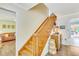 Wooden staircase in a well-lit hallway with access to the living room at 2165 Lemon Ave, Englewood, FL 34223