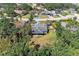 Aerial view of home with large lawn, screened patio and mature landscaping in a quiet neighborhood at 2303 58Th E St, Palmetto, FL 34221