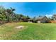 Well maintained backyard features lush greenery and a fire pit at 2303 58Th E St, Palmetto, FL 34221