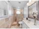 Bathroom featuring tiled walk-in shower, window, and vanity with bouquet at 2303 58Th E St, Palmetto, FL 34221