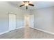 Bedroom with wood-look tile, closet, and door leading to additional rooms at 2303 58Th E St, Palmetto, FL 34221
