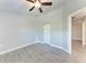 Bright bedroom features wood-look tile flooring, ceiling fan, and neutral wall color at 2303 58Th E St, Palmetto, FL 34221